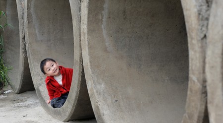 cuet little boy in Sewerの写真素材