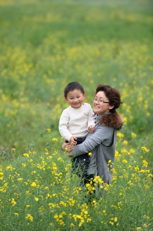 mother and son outdoor in flowersの写真素材