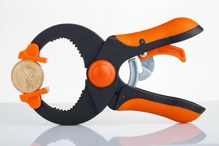 1 dollar coin clamped on the two sides of the clamp driveの写真素材