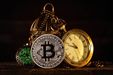 Bitcoin next to the clock and the magical amulet