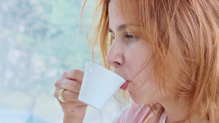 Portrait of young pretty woman drinking coffee