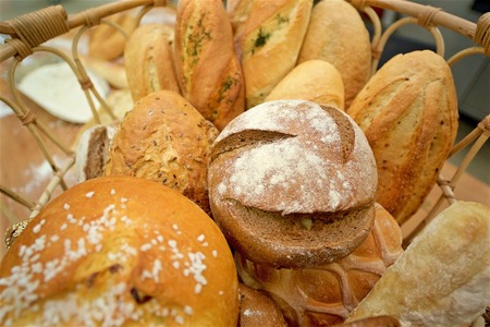 Concept shot of many mixed breads and baguette in the basket, above perspective
