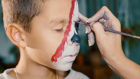 Make-up artist makes the boy halloween make up. Halloween child face art.の写真素材