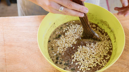 Cook mixes ingredients for dough in plastic bowl