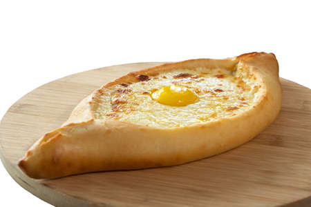 An adjarian khachapuri on wooden board, isolate.の写真素材
