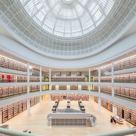 Interior of a public library with rows of books and tables.の写真素材