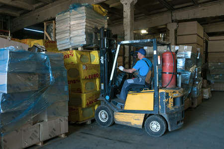 SAINT PETERSBURG, RUSSIA - AUGUST 10, 2021: A forklift truck works at a warehouse of construction materialsのeditorial素材