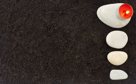 Stones and candle on a dark background, spaの写真素材