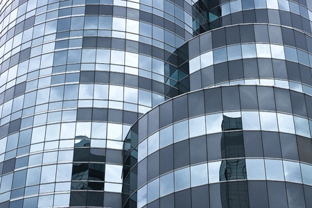 Curve modern glass facade, dark cloud reflectionの写真素材
