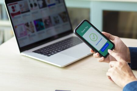 using smartphone and laptop online shoppingの写真素材