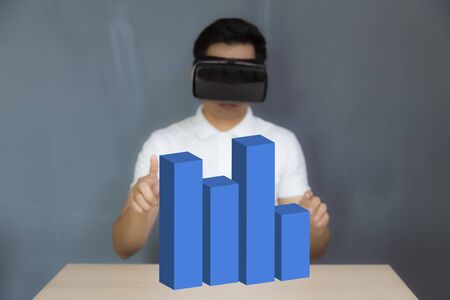 Man wearing the virtual reality goggles touch 3d sceneの写真素材