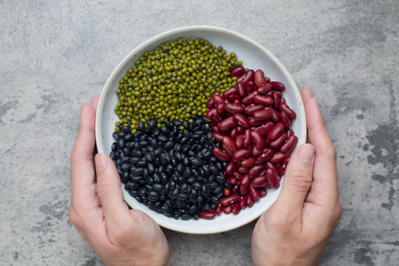 mung bean in bowl and wood spoon on white background studio shotの写真素材