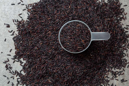 plastic spoon a pile of ricebery riceの写真素材