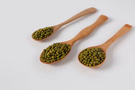 mung bean in wood spoon on white background studio shotの写真素材