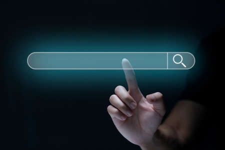 Search technology, search engine optimization, man's hand using virtual screen to search information, using search bar function on your website. SEO.の写真素材