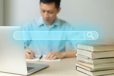 Search technology, search engine optimization, man's hand using Laptop computer or smartphone to search information, using search bar function on your website. SEO.の写真素材