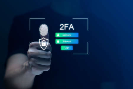 Businessman touching virtual screen to fingerprint scan for two-factor authentication for safety use of social networks and access to information privacyの写真素材