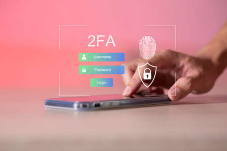Businessman touching smartphone and using virtual screen for two-factor authentication for safety use of social networks and access to information privacyの写真素材