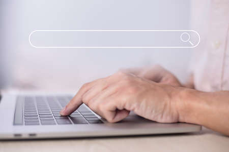 Search technology, search engine optimization, man's hand using laptop to search information, using search bar function on your website. SEO.の写真素材