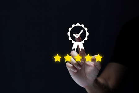 Businessman showing sign of leading service, 5 star quality assurance, warranty, standardization, ISO certification and standardization concept.の写真素材