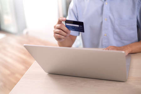shopper using laptop online shopping. And using credit card online payment option or digital wallet...