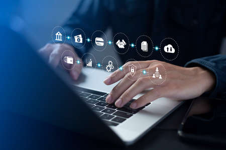 Businessman using laptop and virtual touch screen o do online transactions with internet technology,...