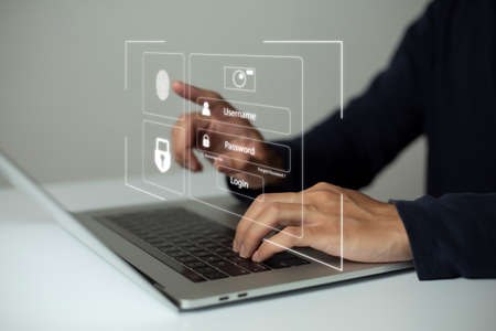 Person using laptop and touching virtual screen for two-factor authentication for safety use of social networks and access to information privacyの写真素材