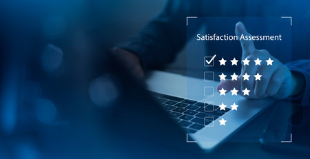 Satisfaction and customer service survey concept, business people using  laptop. to answer the questionnaire And the satisfaction rating, the satisfaction rating with the icon 5 stars.の写真素材