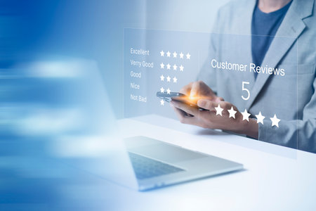 Satisfaction and customer service survey concept, business people using  laptop and smartphone. to answer the questionnaire And the satisfaction rating, the satisfaction rating with the icon 5 stars.の写真素材