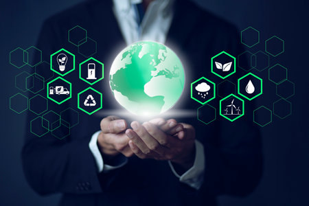 Businessman holding world with economy system icon digital sustainability and Sustainable Technology conceptの写真素材