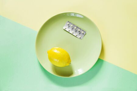Paper background and pill on it, lemon and ginger.の写真素材