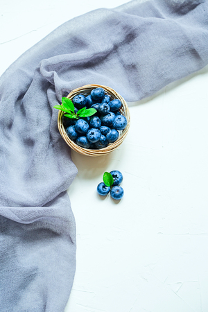 Fresh blueberries on white background. Top view, copy space, textile.の写真素材