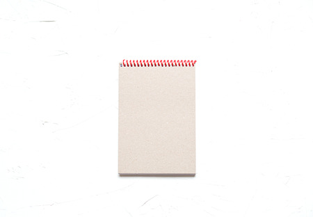 Blank shift of a notebook on a white tableの写真素材