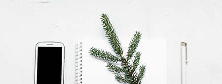 Office supplies flat lay on white. A notebook, a pen, a cup of coffe, a mobile.の写真素材