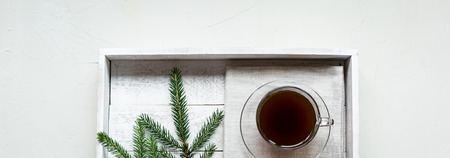 A cup of hot black coffee on a white wooden tray. Breakfast. Top view