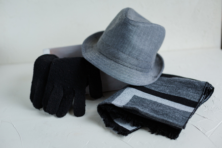 Flat lay of male clothes and accessories. Grey hat, woolen scarf, black gloves.の写真素材