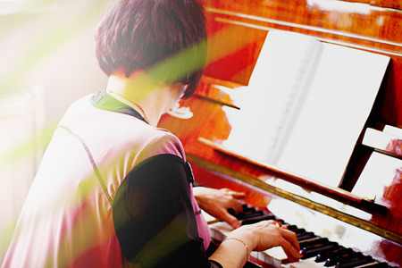 A piano player or a teacher of music. Hans of a musician on piano keys.の写真素材