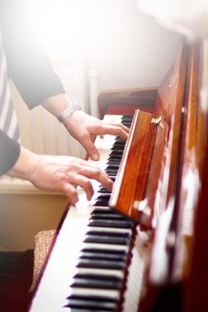 A piano player or a teacher of music. Hans of a musician on piano keys.の写真素材