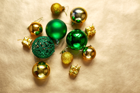 Christmas green baubles on golden paper background. Copy space, holiday concept.の写真素材