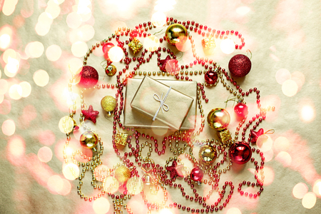 Christmas flat lay of golden and red shiny toys and beads on paper background. Top view.の写真素材