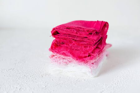 Closed up view of pink and white textile on white background. Gauze or cotton samples or clothes.の写真素材