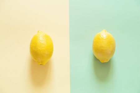 Top view of two colored paper background and Home treatment with fresh lemons.の写真素材