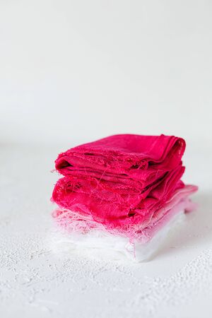 Closed up view of pink and white textile on white background. Gauze or cotton samples or clothes.の写真素材