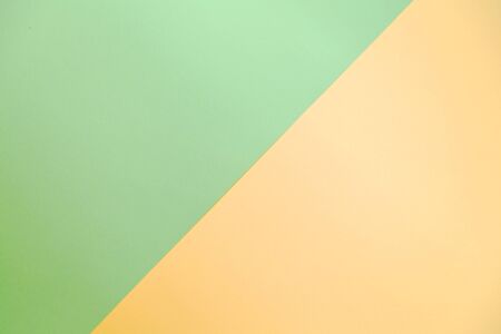 Paper background of two colors yellow and green. Lemon yellow and mint green. Double colored paper.の写真素材