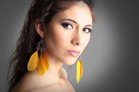 cute girl with beautiful yellow earringsの写真素材