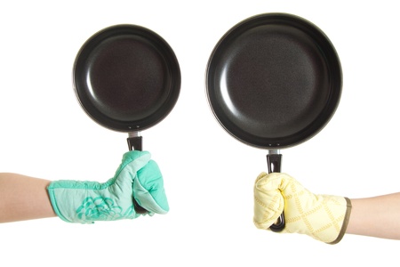 two hands in gloves holding pan's isolated on whiteの写真素材