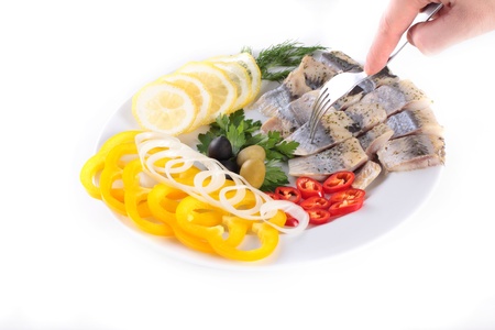 fish on plate with vegetables isolated on whiteの写真素材