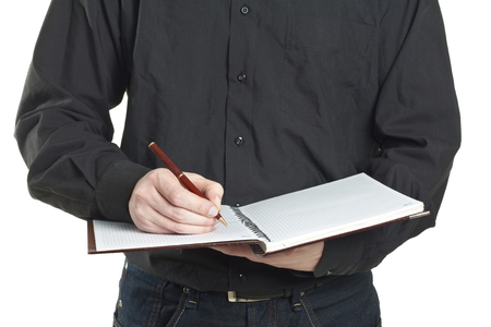 businessman taking note in a notepad at officeの写真素材