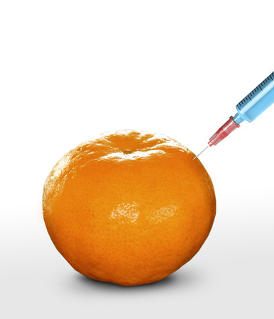 syringe sticked into orange,GMOの写真素材
