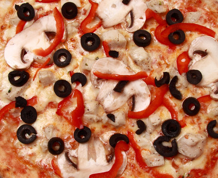 Pepperoni pizza with mushrooms, shrimps and olives backgroundの写真素材
